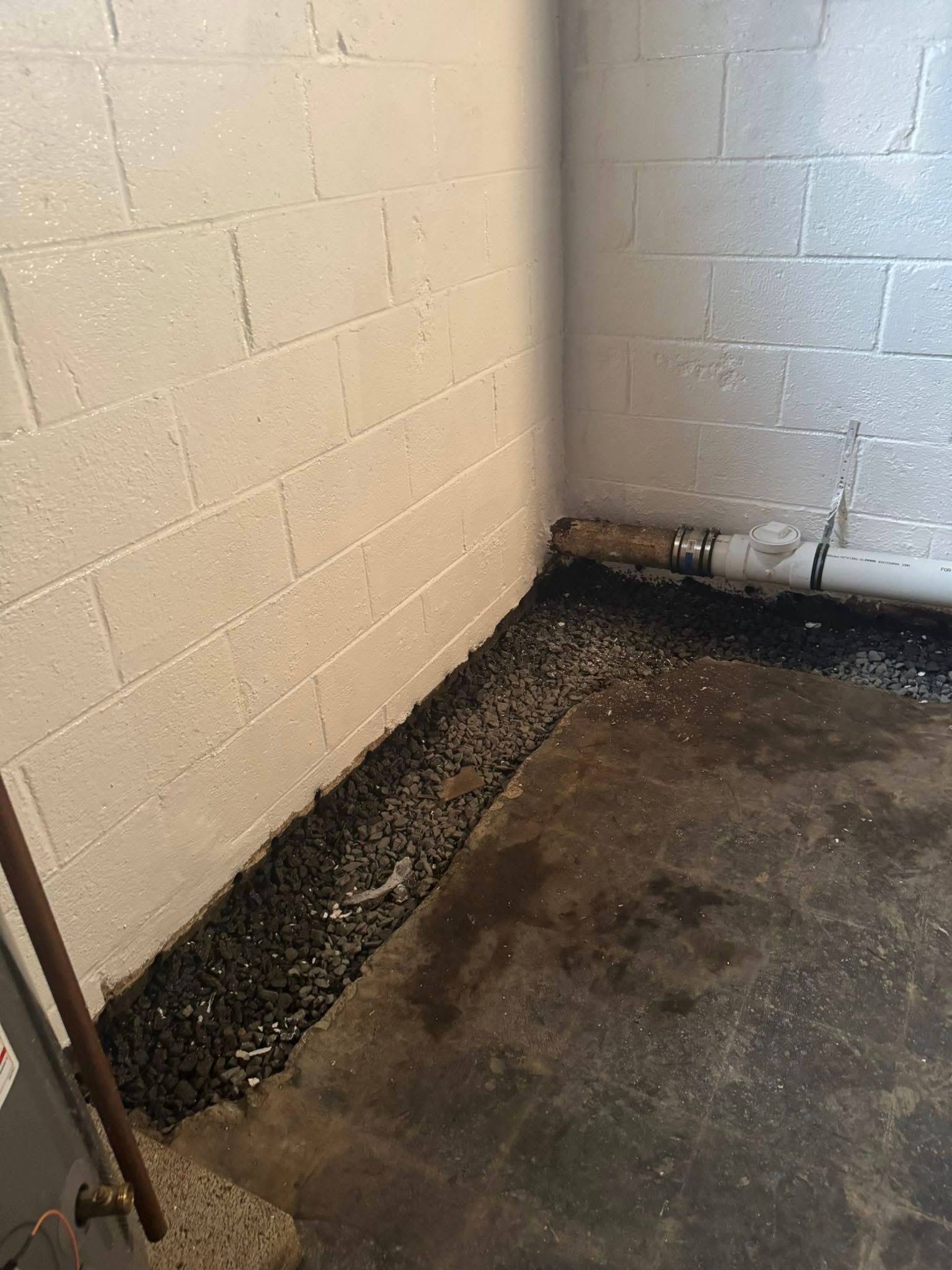 A room with a brick wall and a concrete floor.