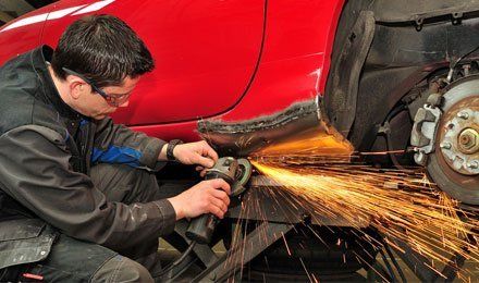 Body shop worker welding car