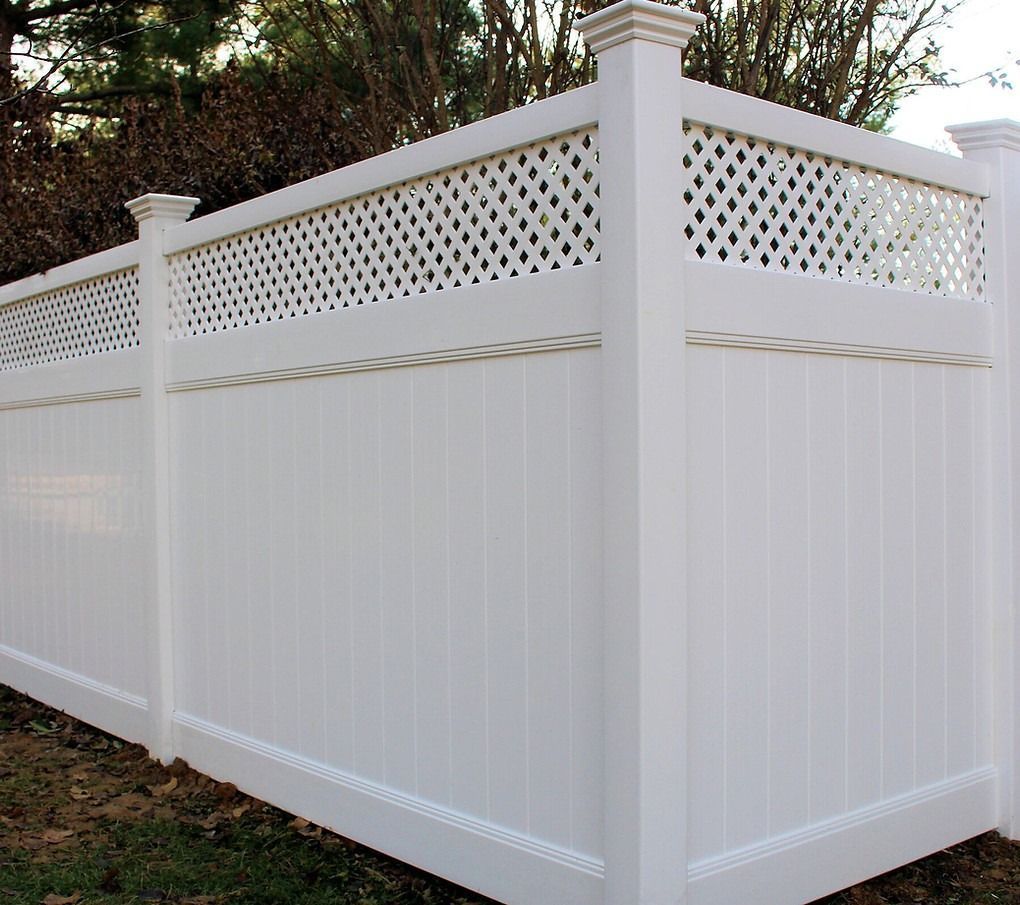 A white fence with a lattice design on it
