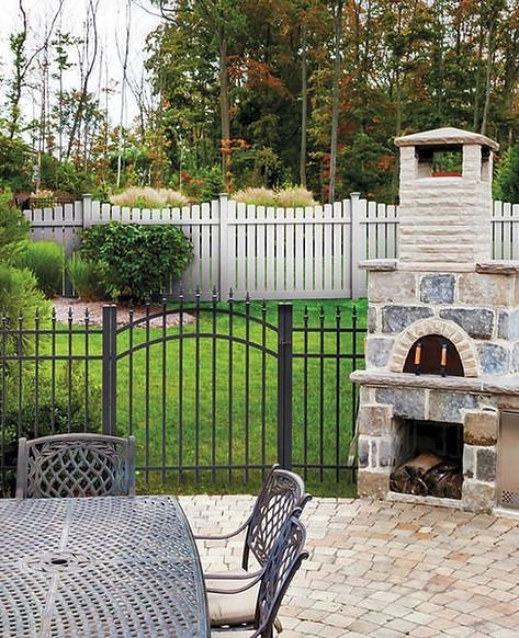 A patio with a table and chairs and a fireplace