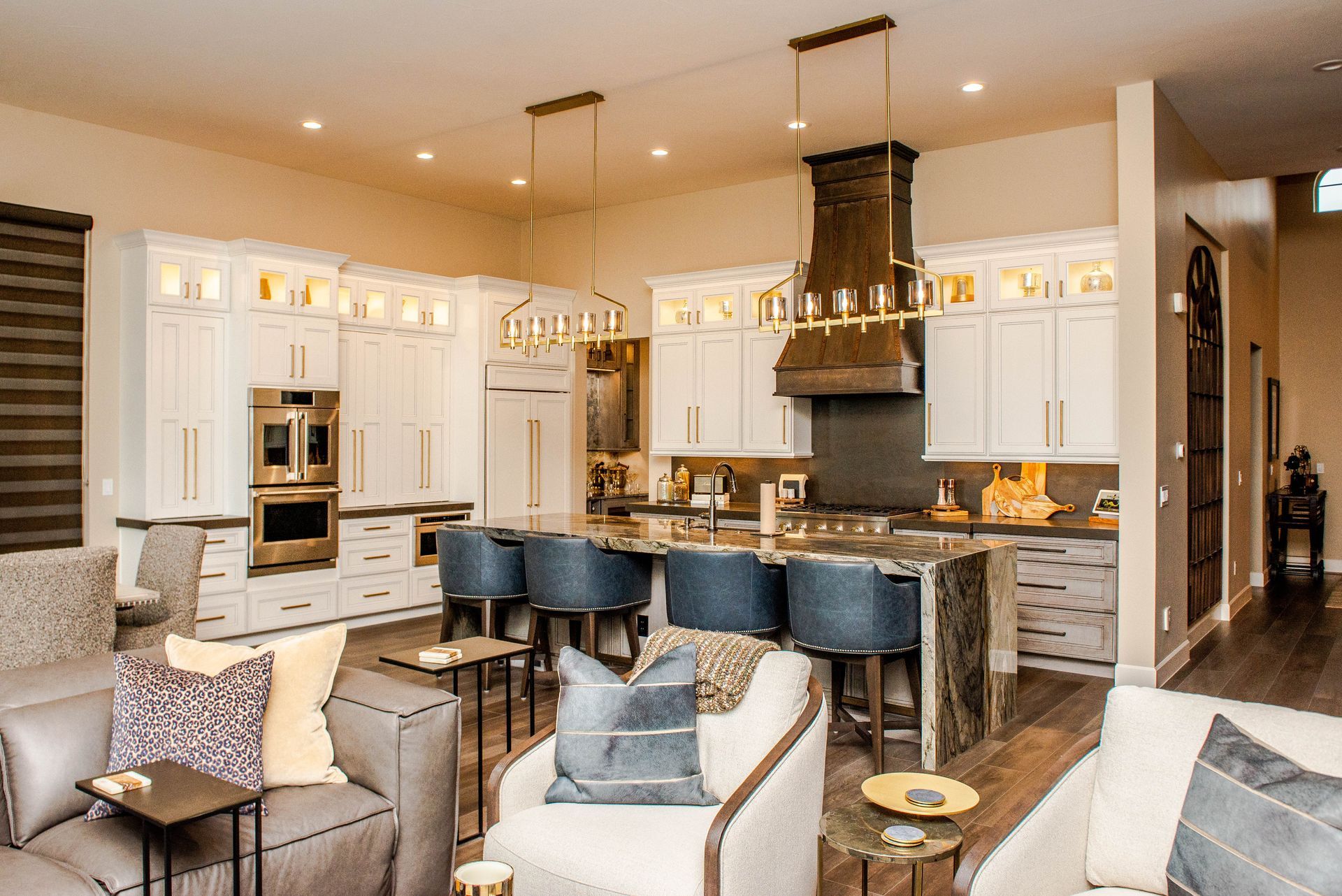 A living room filled with furniture and a kitchen in a house.