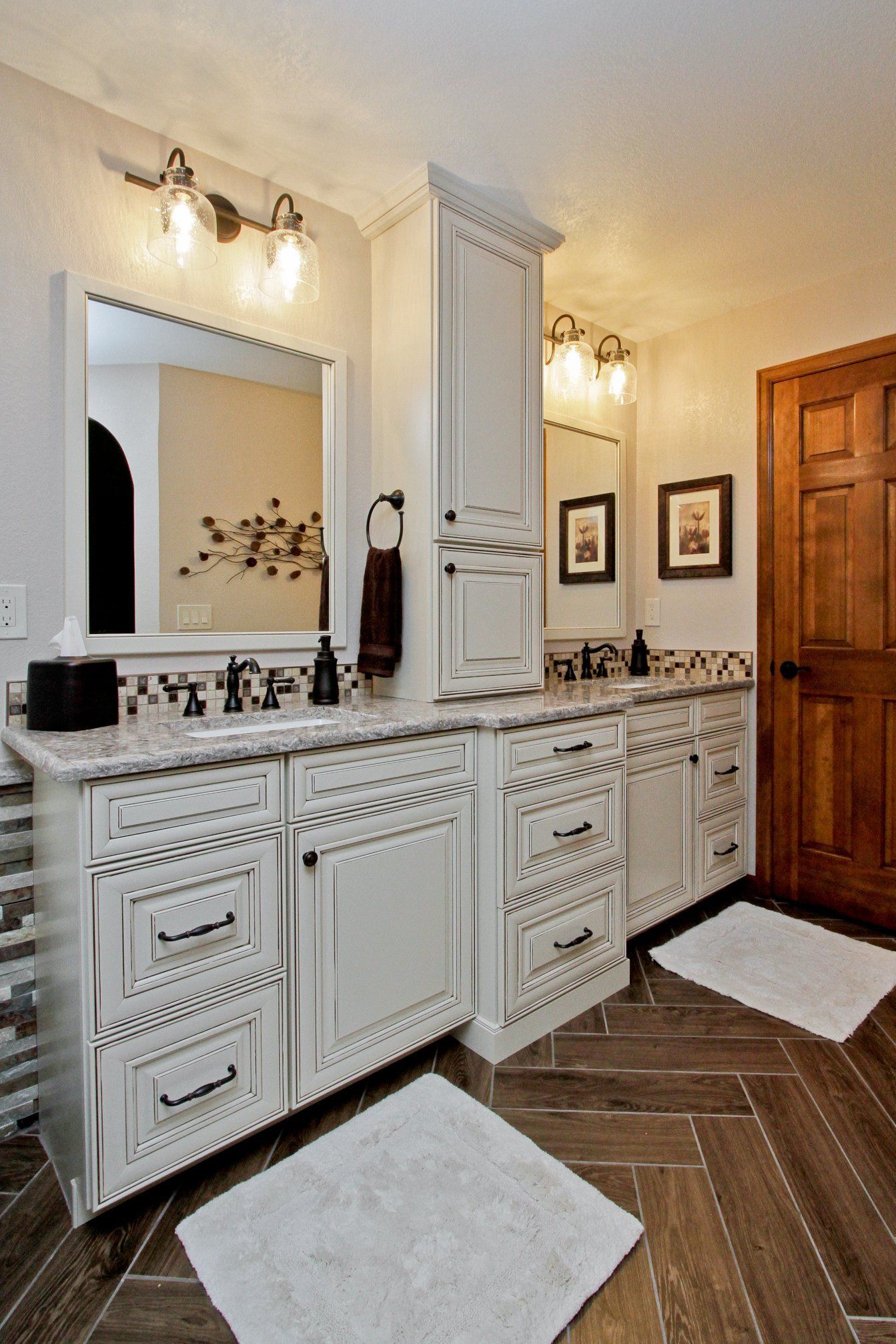 A bathroom with two sinks , a mirror , and a wooden floor.