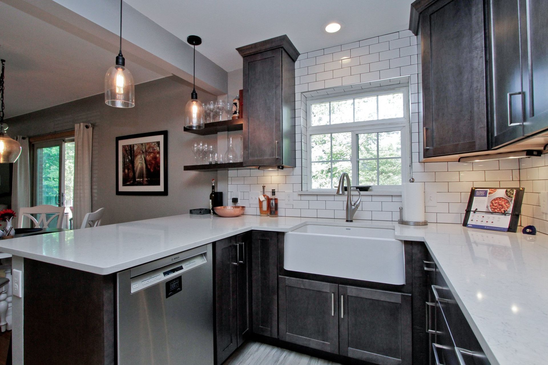 A kitchen with stainless steel appliances and a white sink.