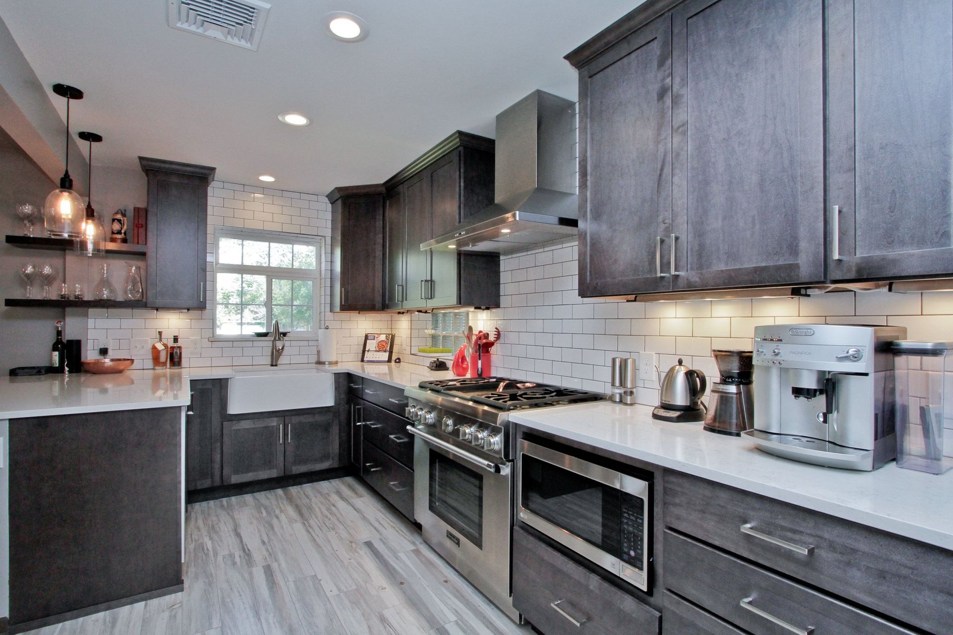 A kitchen with stainless steel appliances and gray cabinets