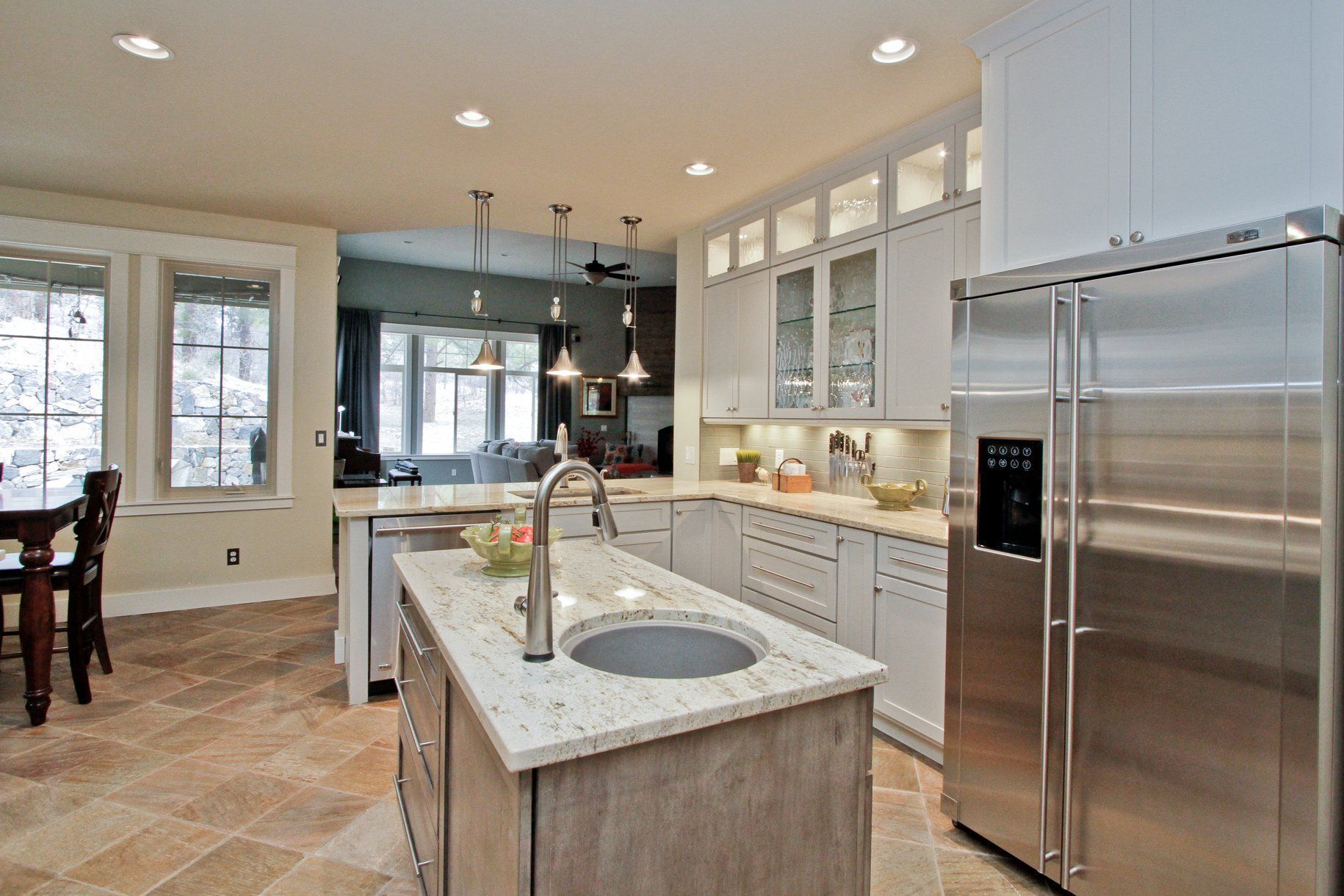 A kitchen with stainless steel appliances and a large island.