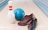 Bowling ball, pin and shoes