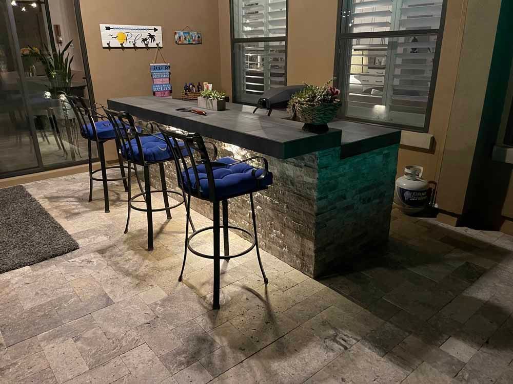 A patio with a table and chairs and a propane tank.
