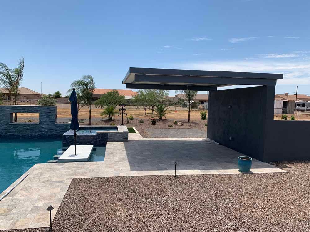 There is a swimming pool in the backyard of a house.
