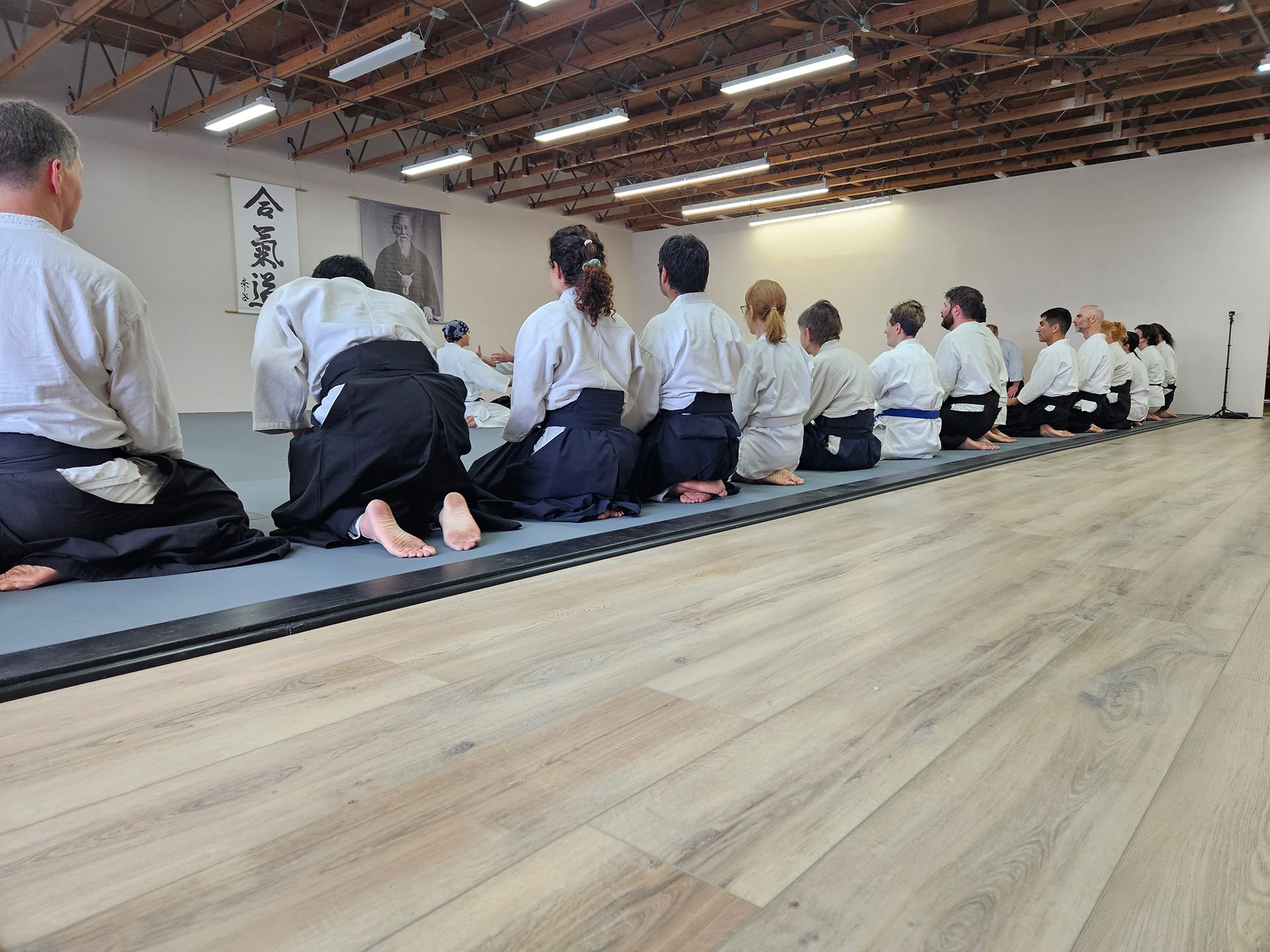 A group of people are sitting on the floor in a room.