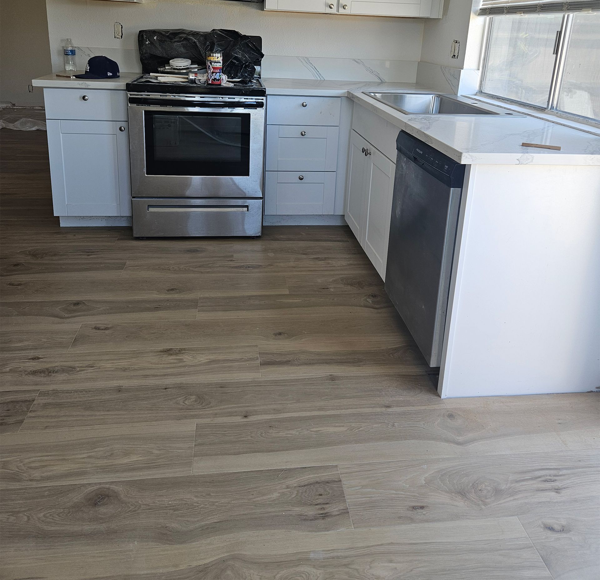 A kitchen with stainless steel appliances and white cabinets