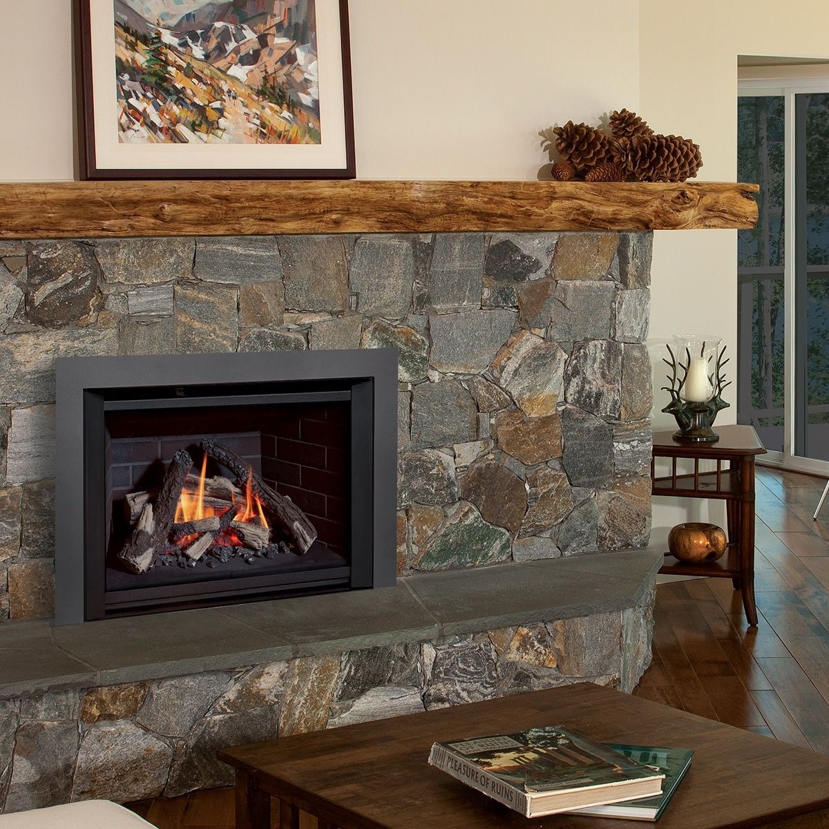 A fireplace in a living room with a picture above it