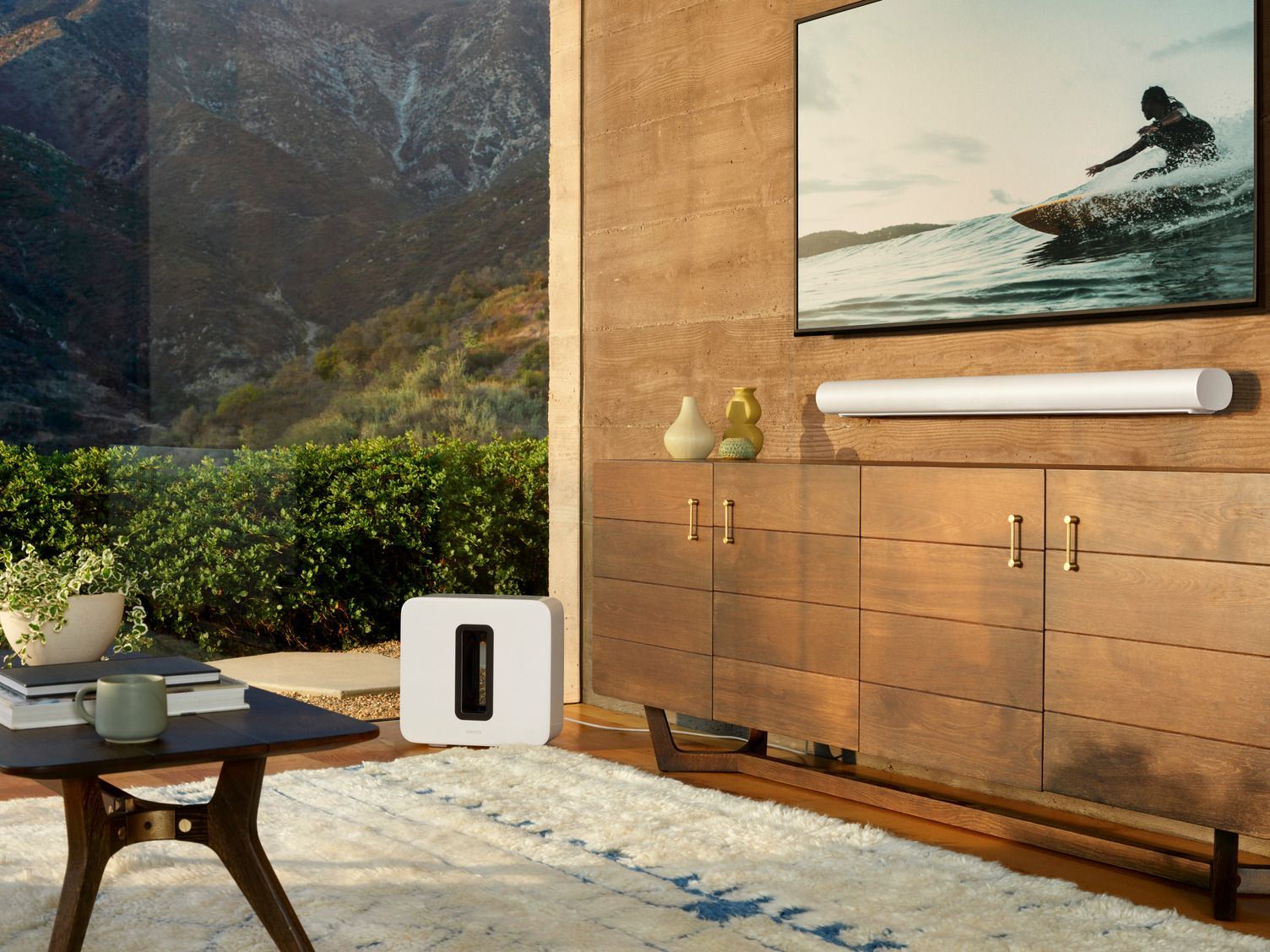 A living room with a television on the wall and a coffee table.