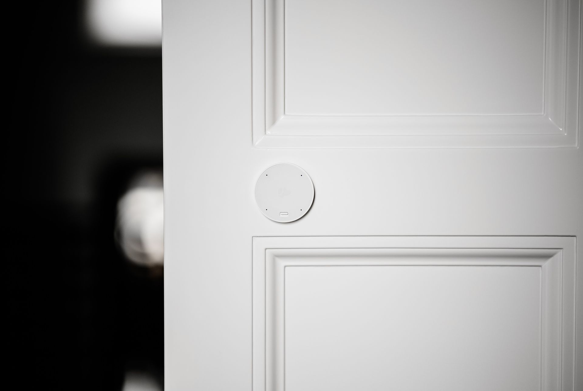 A close up of a white door with a round knob on it.