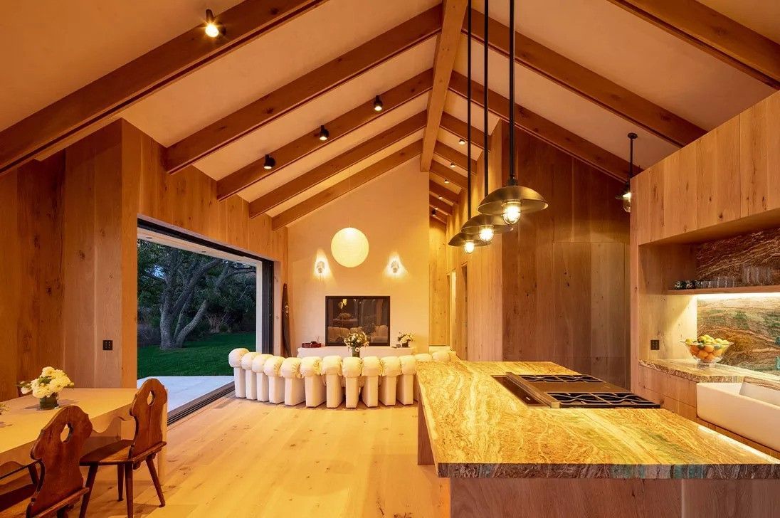 A kitchen with lighting fixtures at night