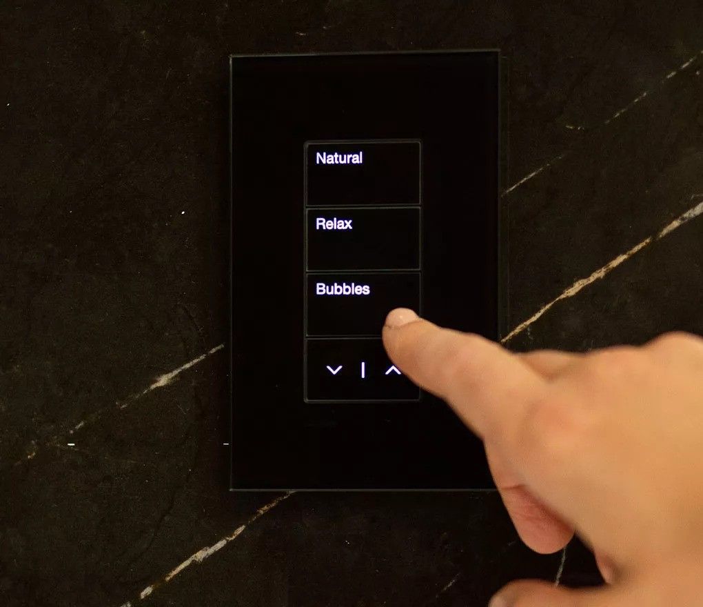 A person is pressing a button that says natural, relax, and bubbles