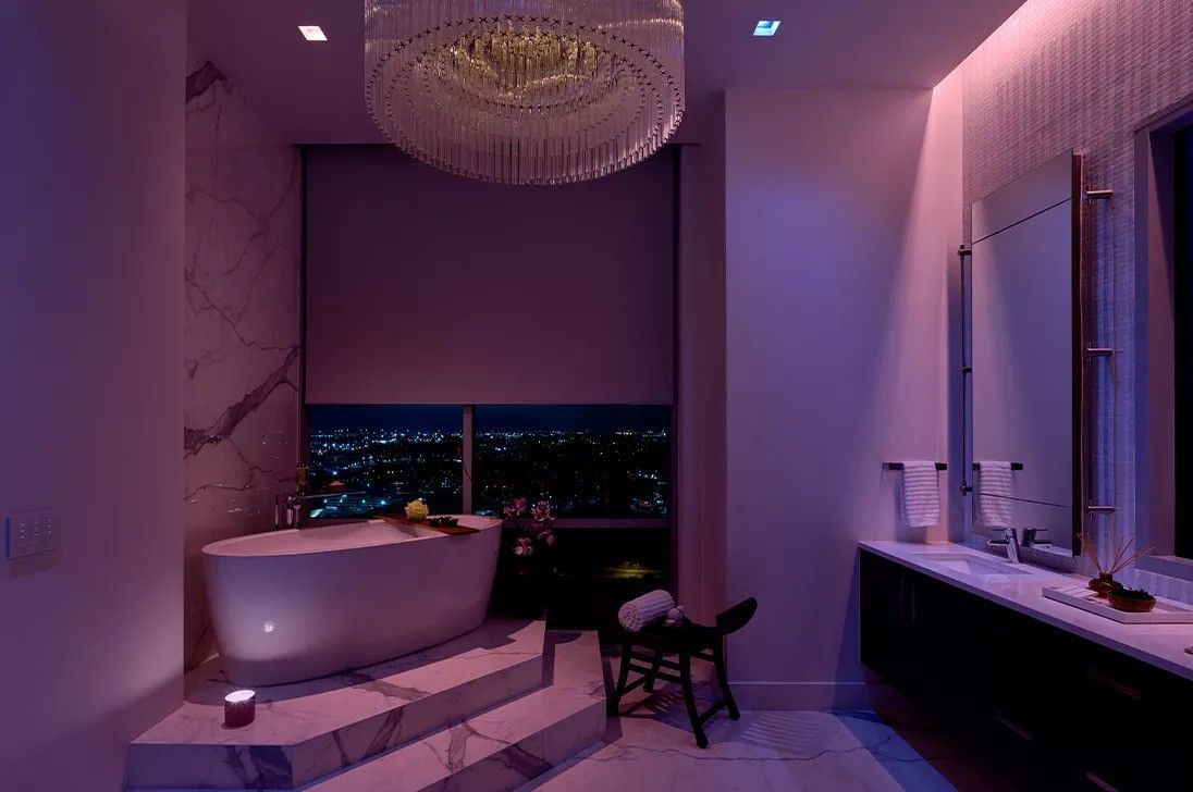 A bathroom with a bathtub and a chandelier hanging from the ceiling