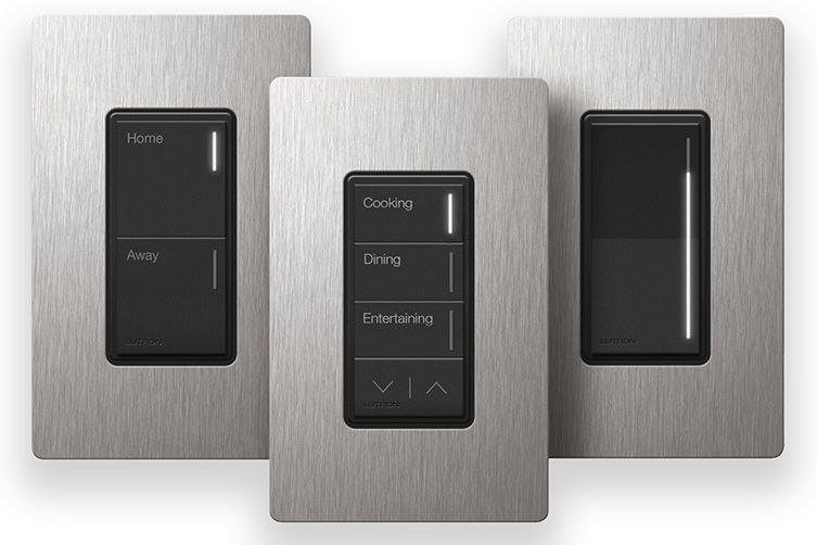 Three stainless steel light switches with black buttons are sitting next to each other on a white background.