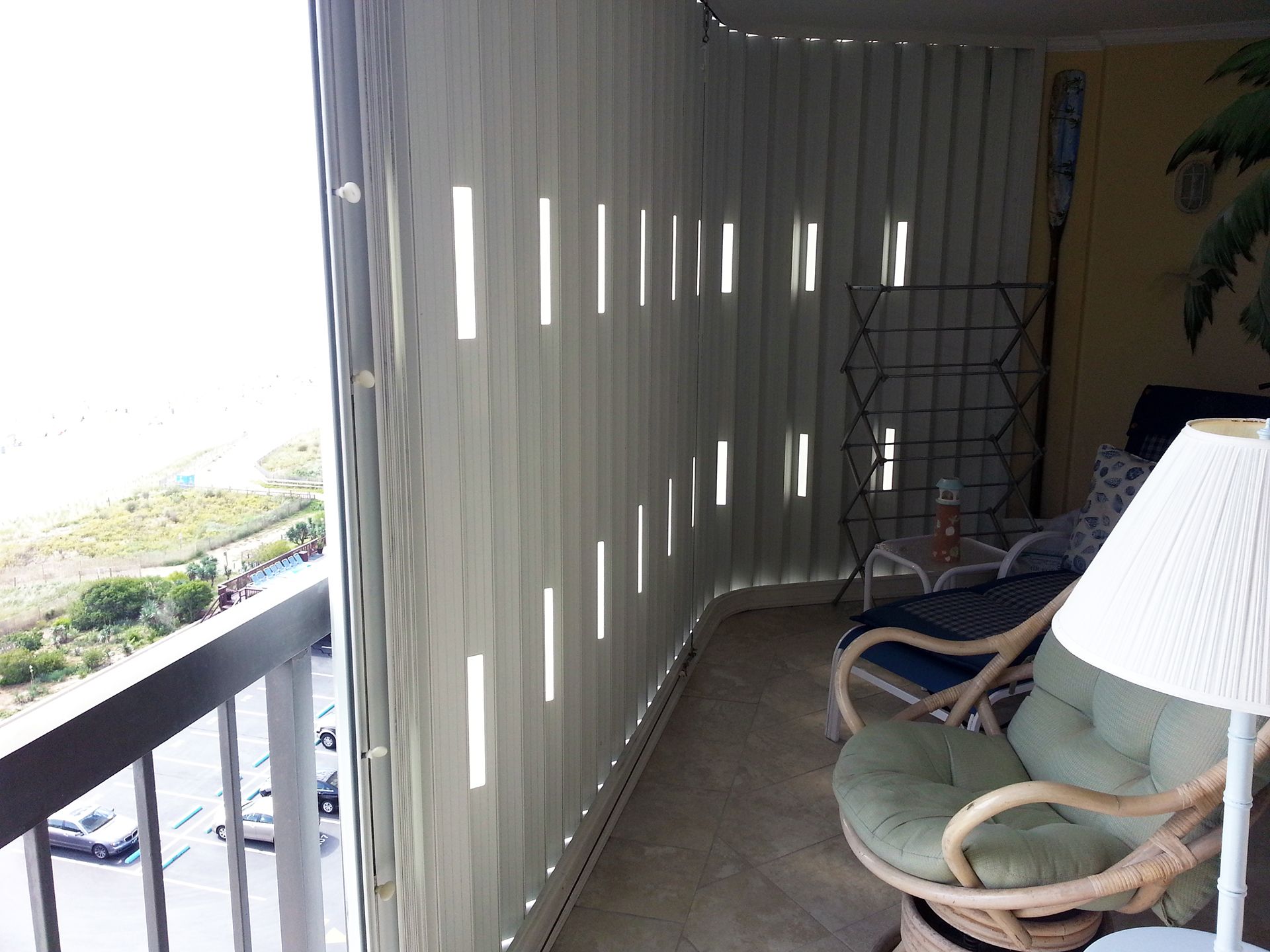 A balcony with an accordion shutter