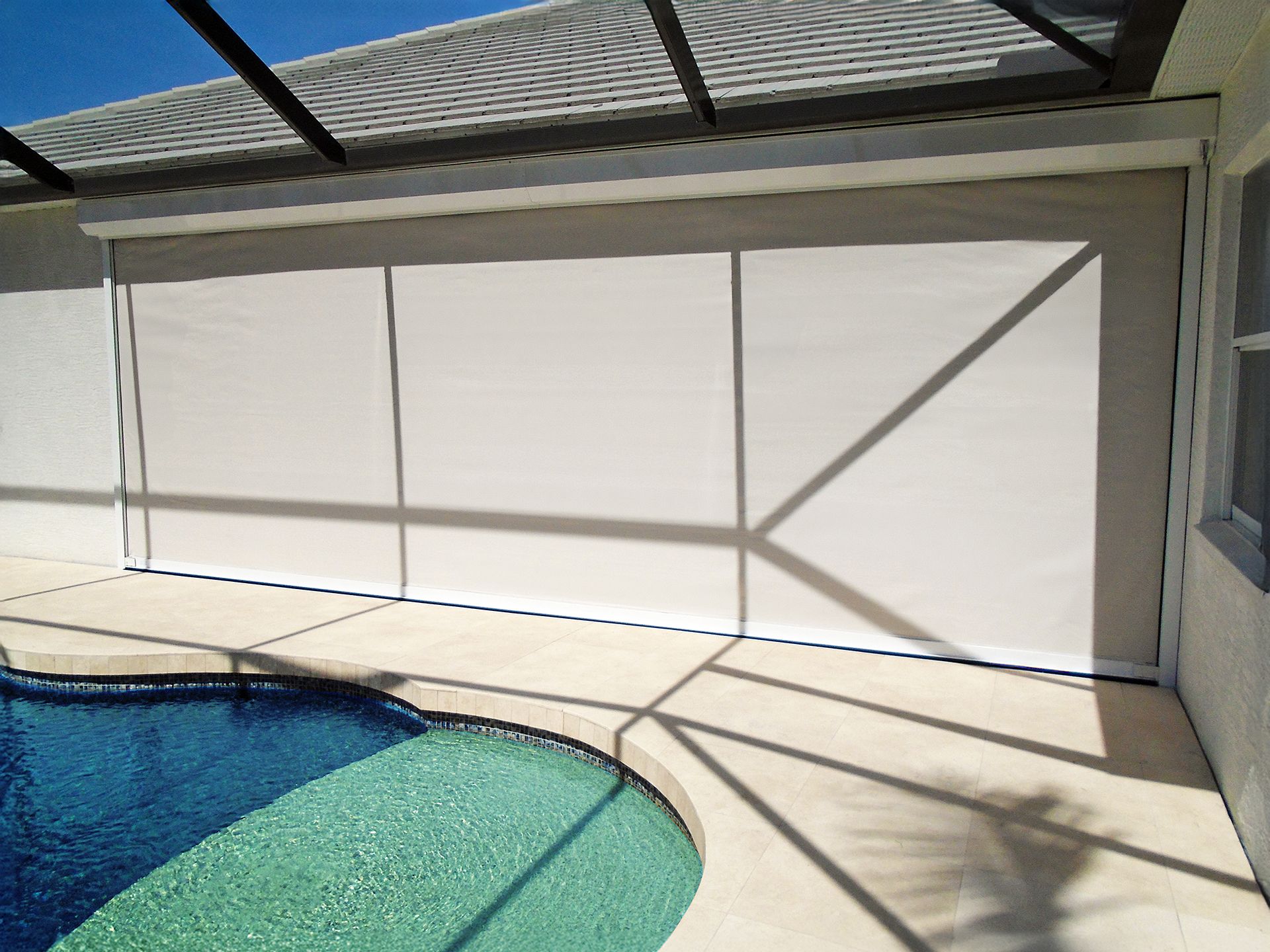 A house with a swimming pool and a screened in porch