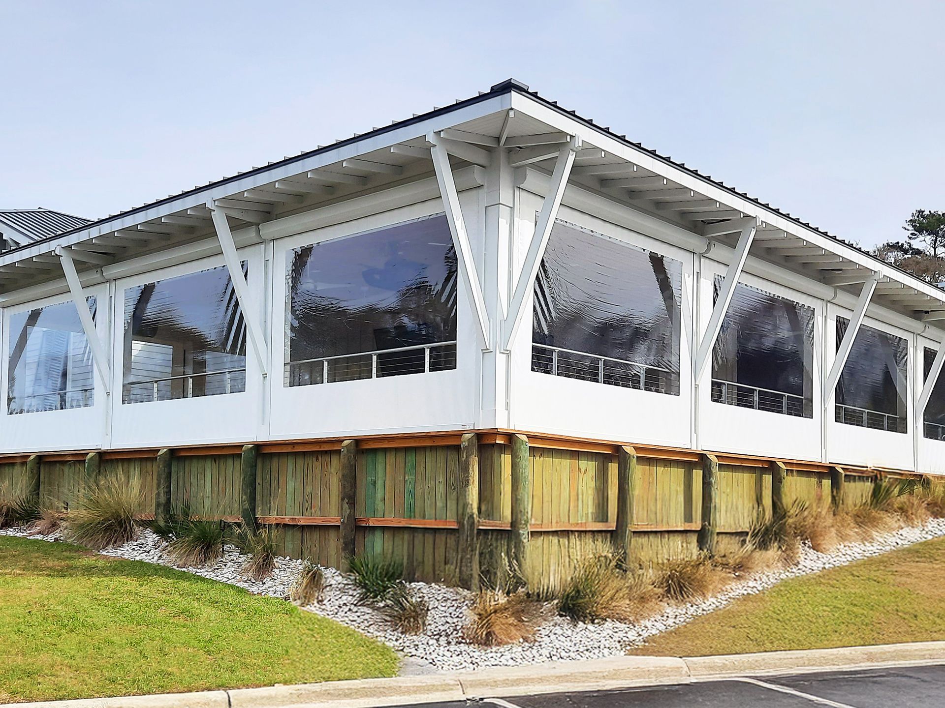 A large white building with a screened in porch