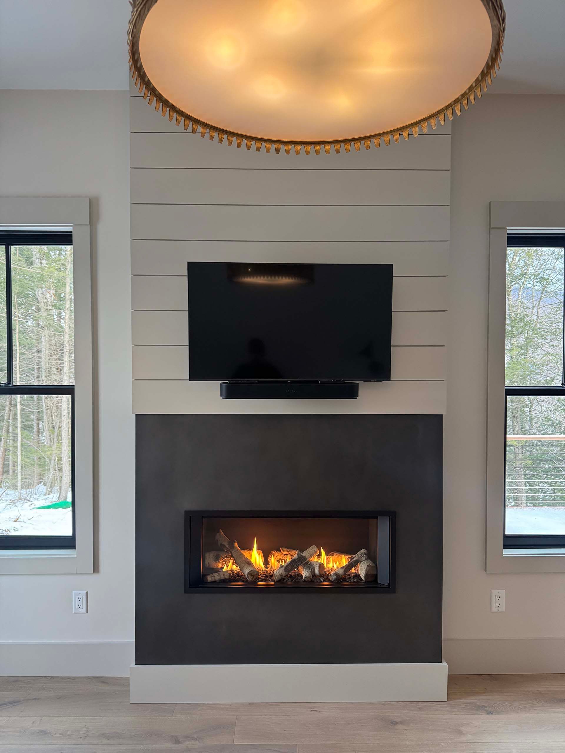 A fireplace with a flat screen tv mounted above it in a living room.