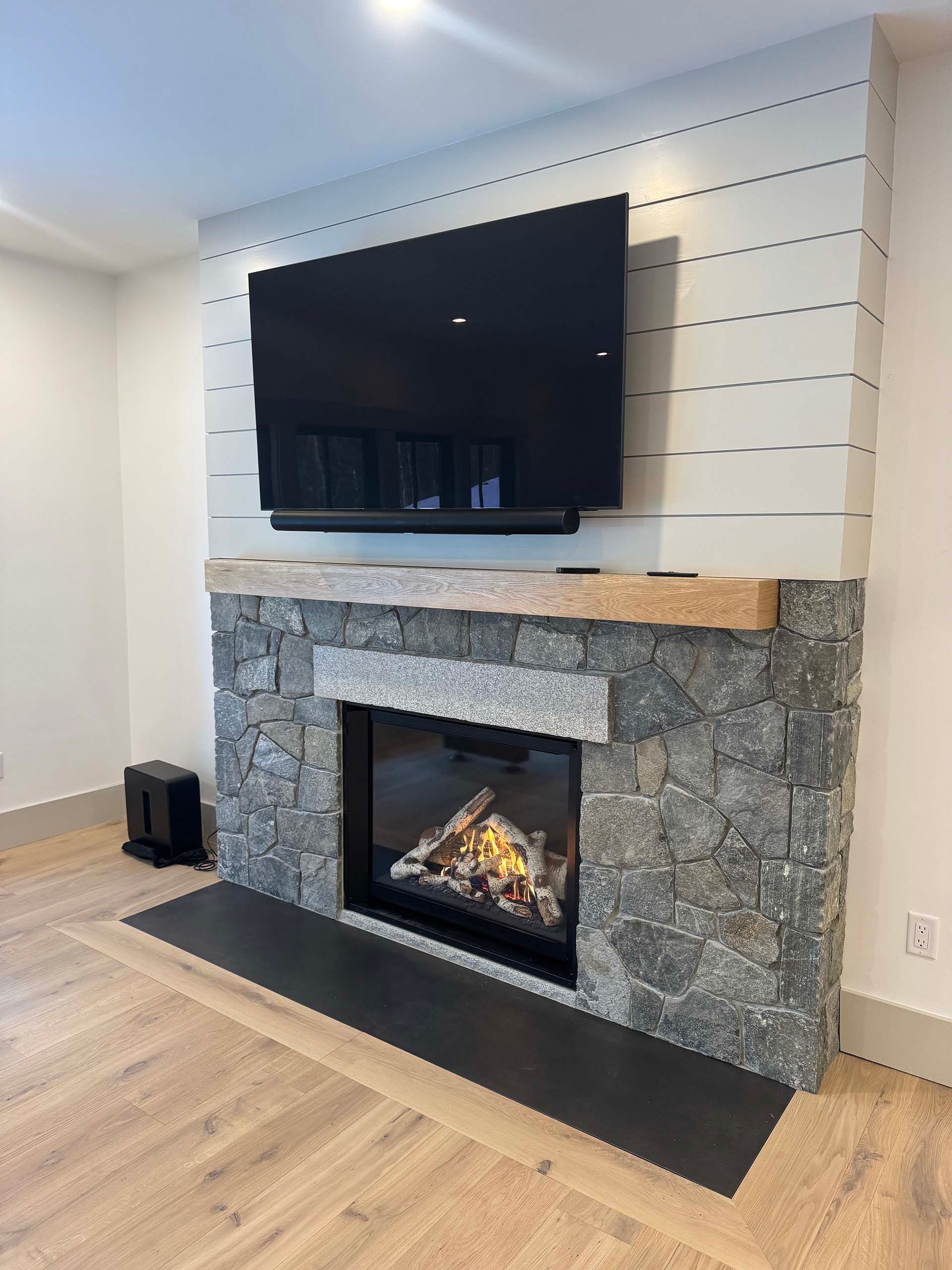 A fireplace with a flat screen tv mounted above it