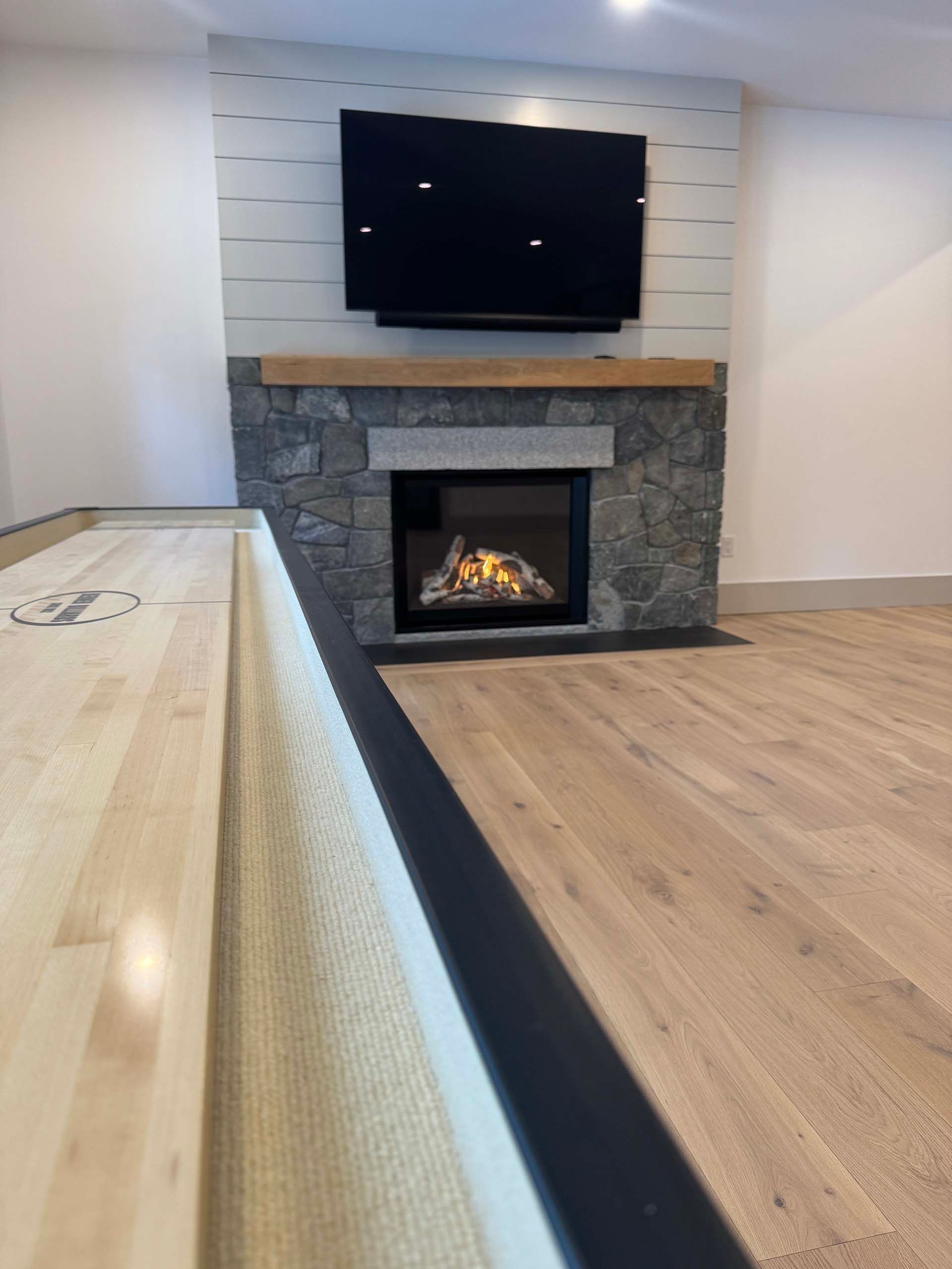 A living room with a fireplace and a flat screen tv