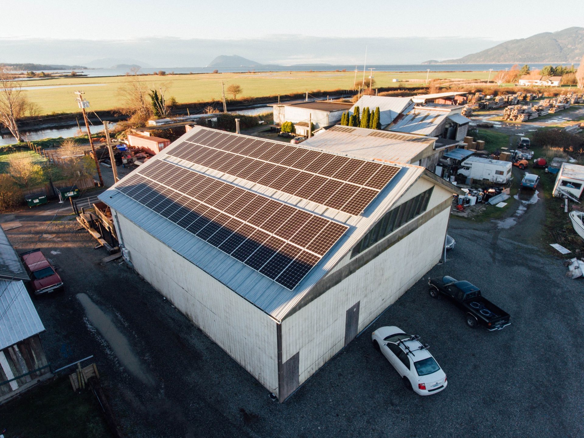 an aerial view of a building with solar panels on the roof