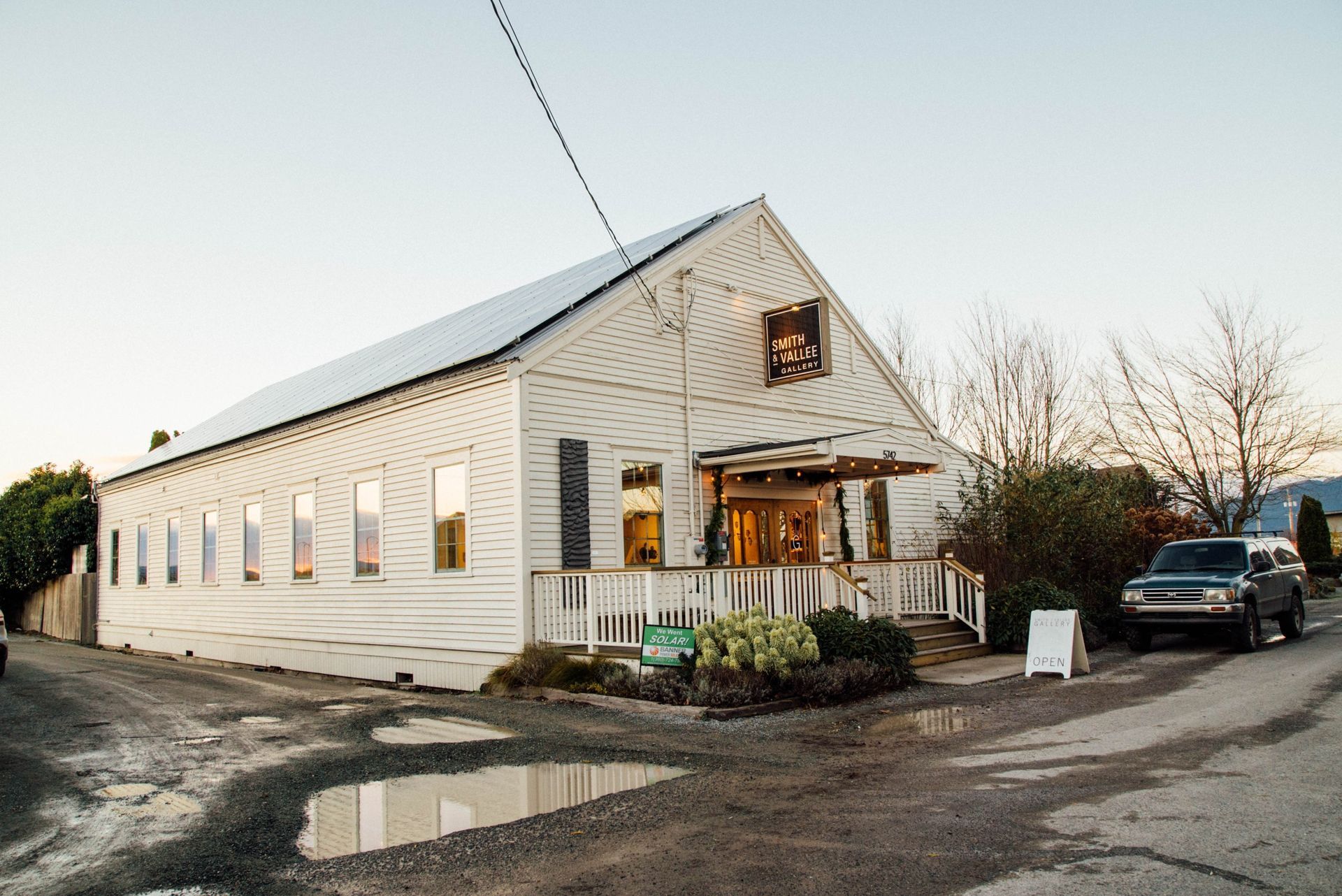 a white building with a car parked in front of it