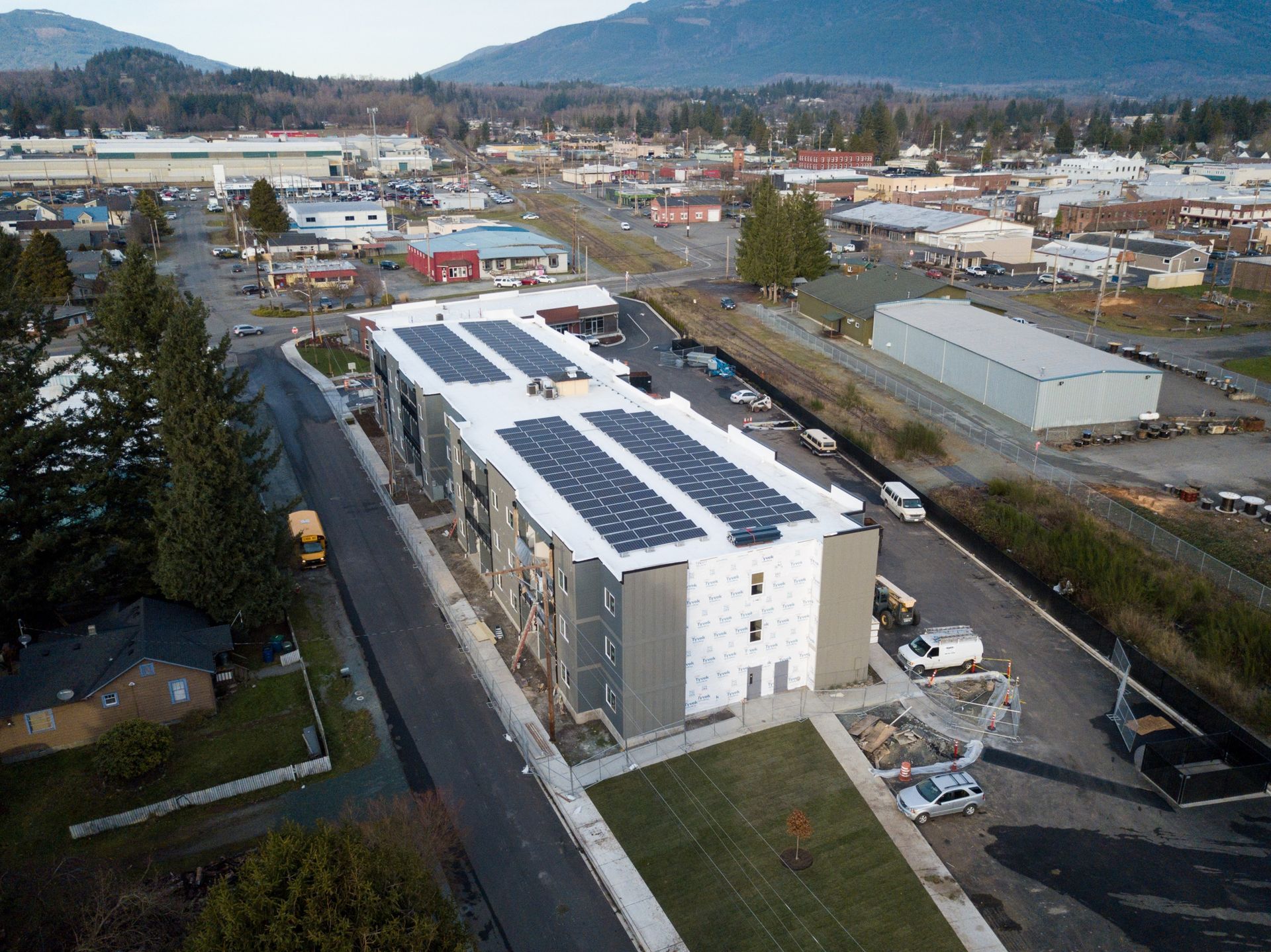 an aerial view of a building with solar panels on the roof