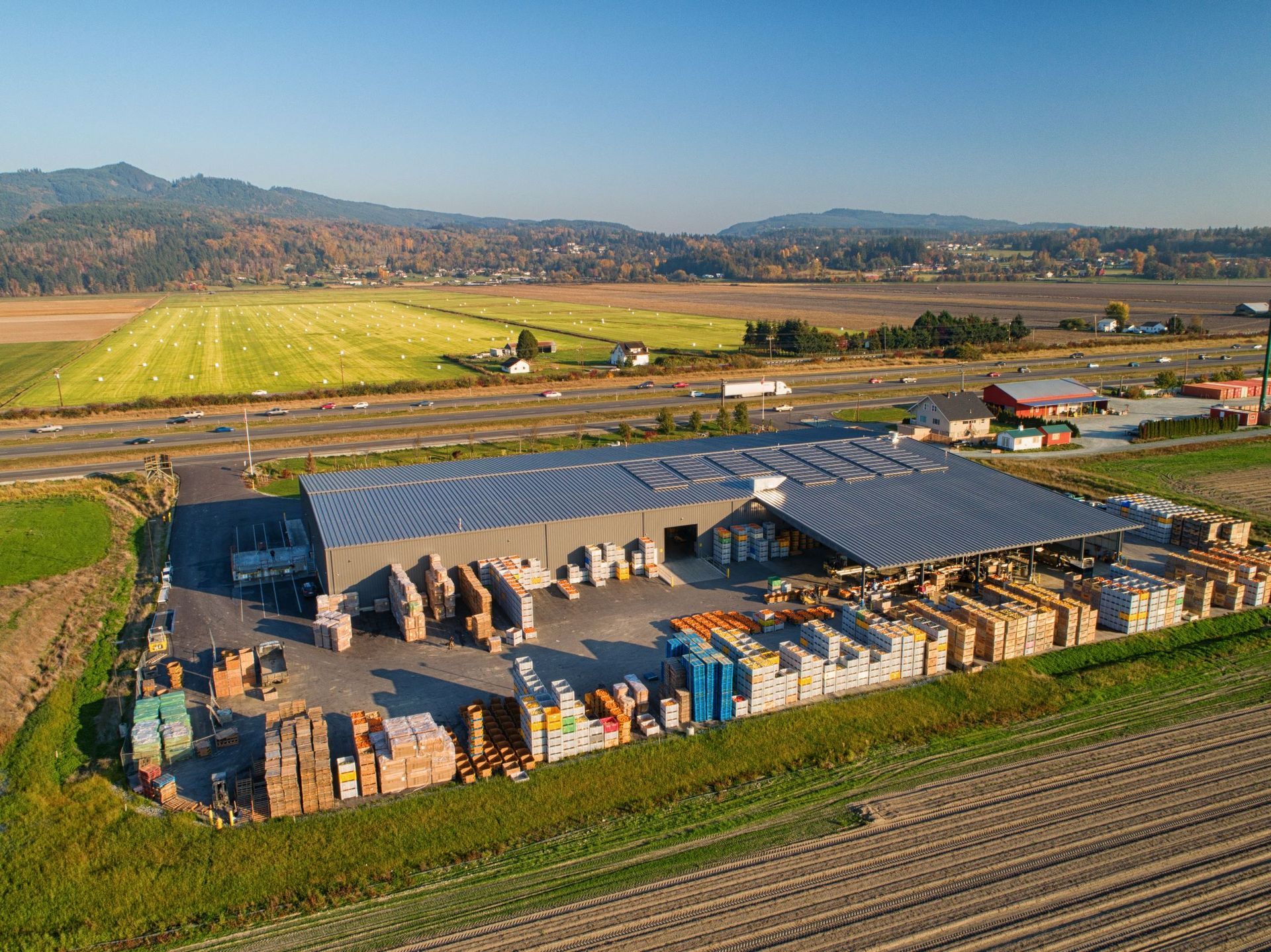 an aerial view of a large warehouse in the middle of a field