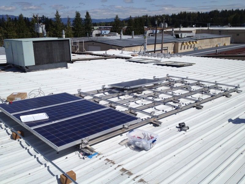 solar panels are being installed on the roof of a building