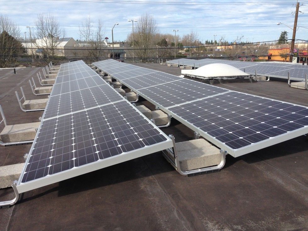 a row of solar panels sitting on top of a roof