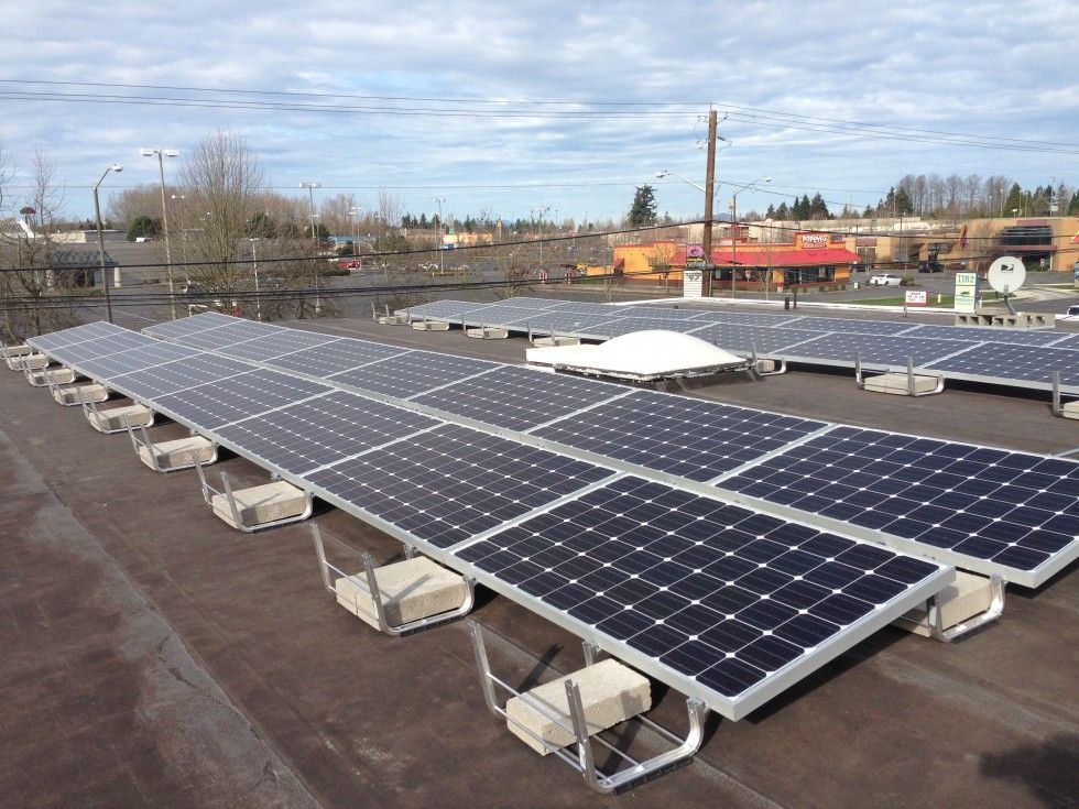 a row of solar panels on the roof of a building
