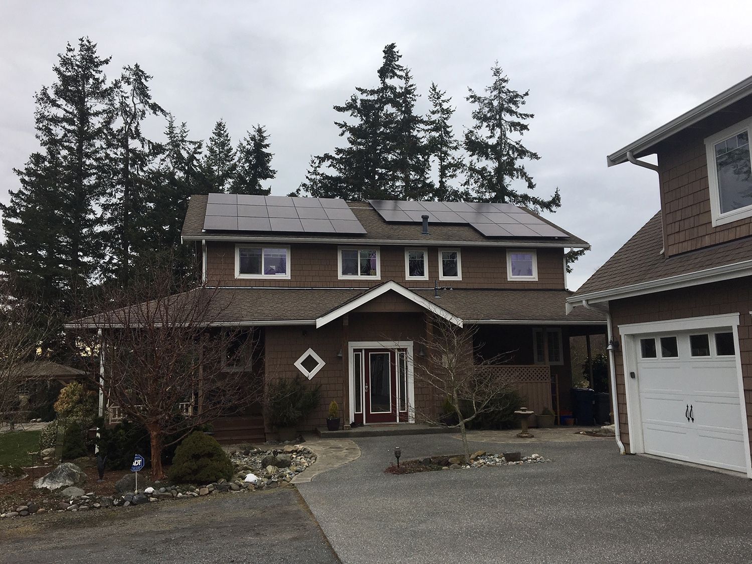 A large brown house with solar panels on the roof