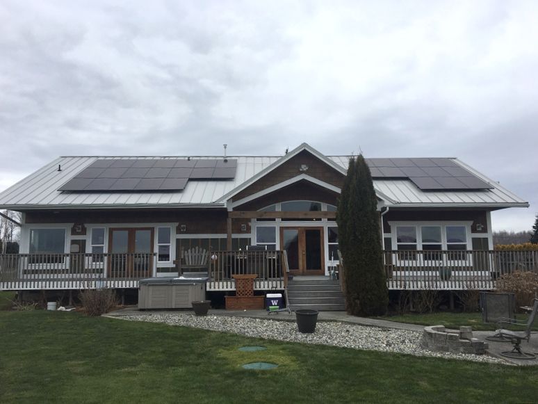 A large house with solar panels on the roof