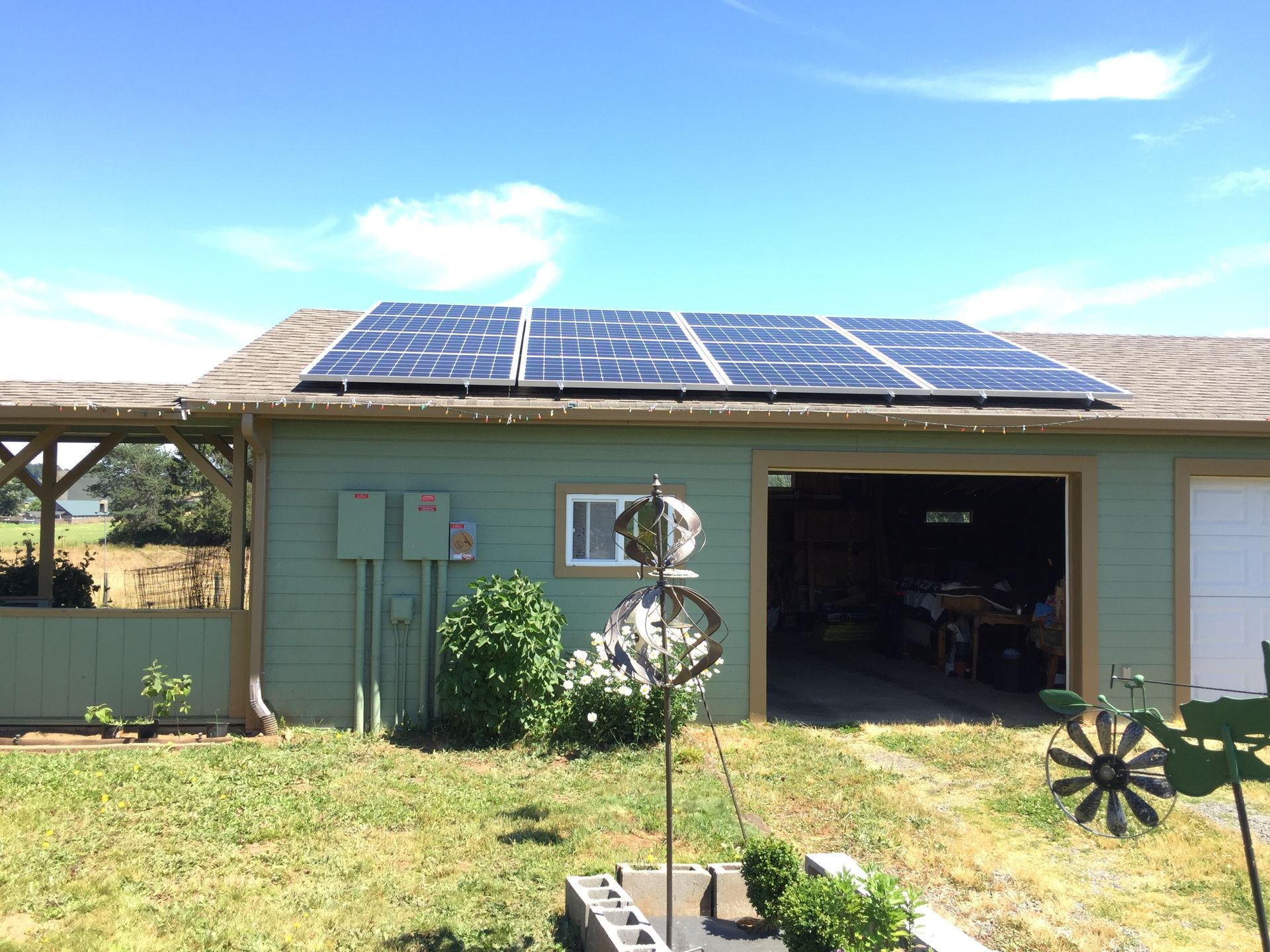 a green house with solar panels on the roof