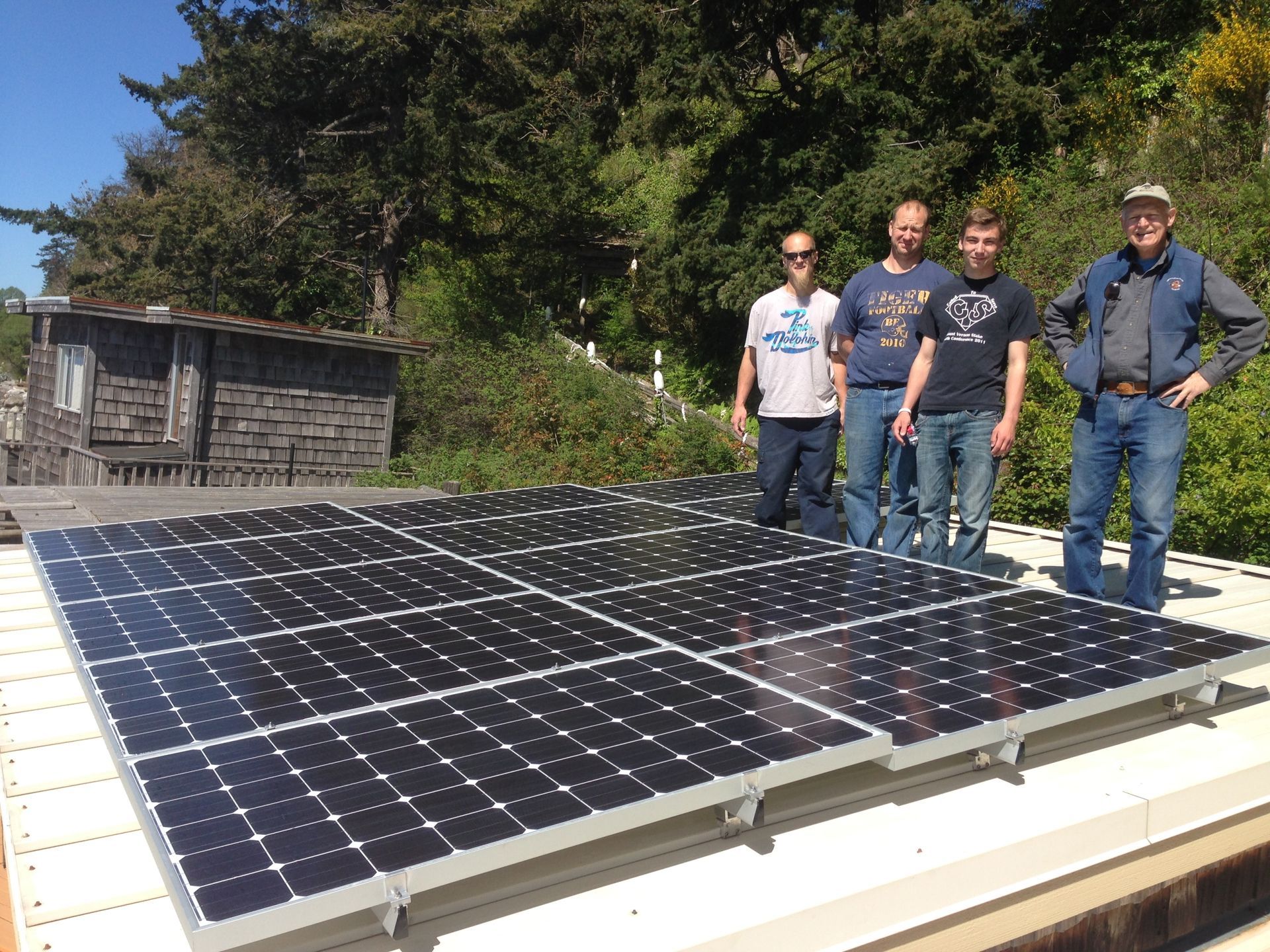 a group of men are standing in front of a large solar panel