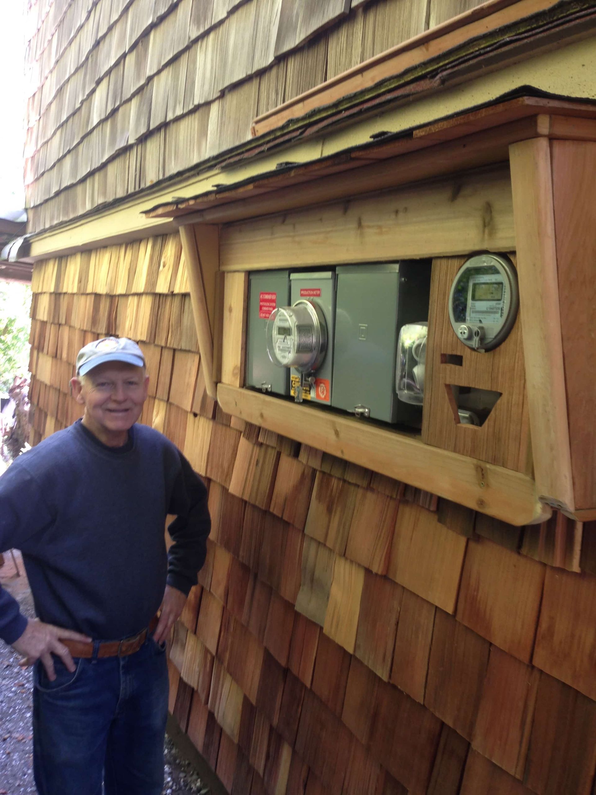 a man is standing in front of a wooden wall
