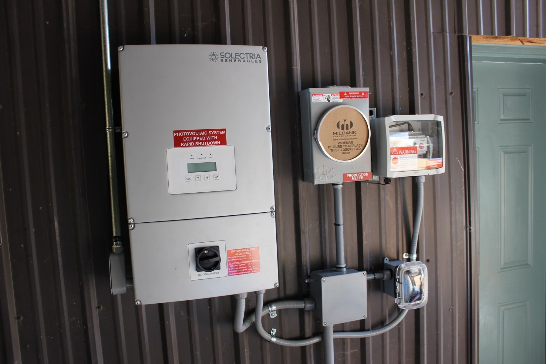 a solar panel inverter is mounted on the side of a building