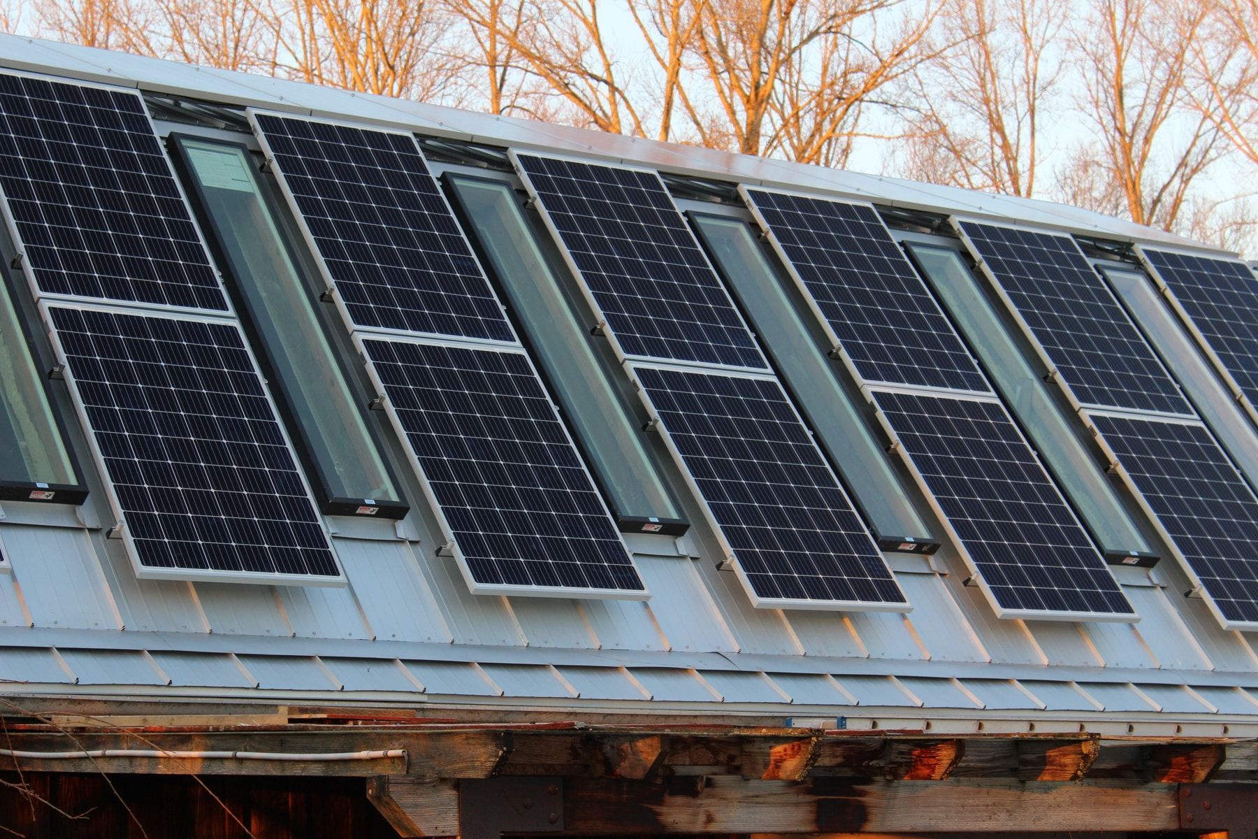 a row of solar panels on the roof of a building