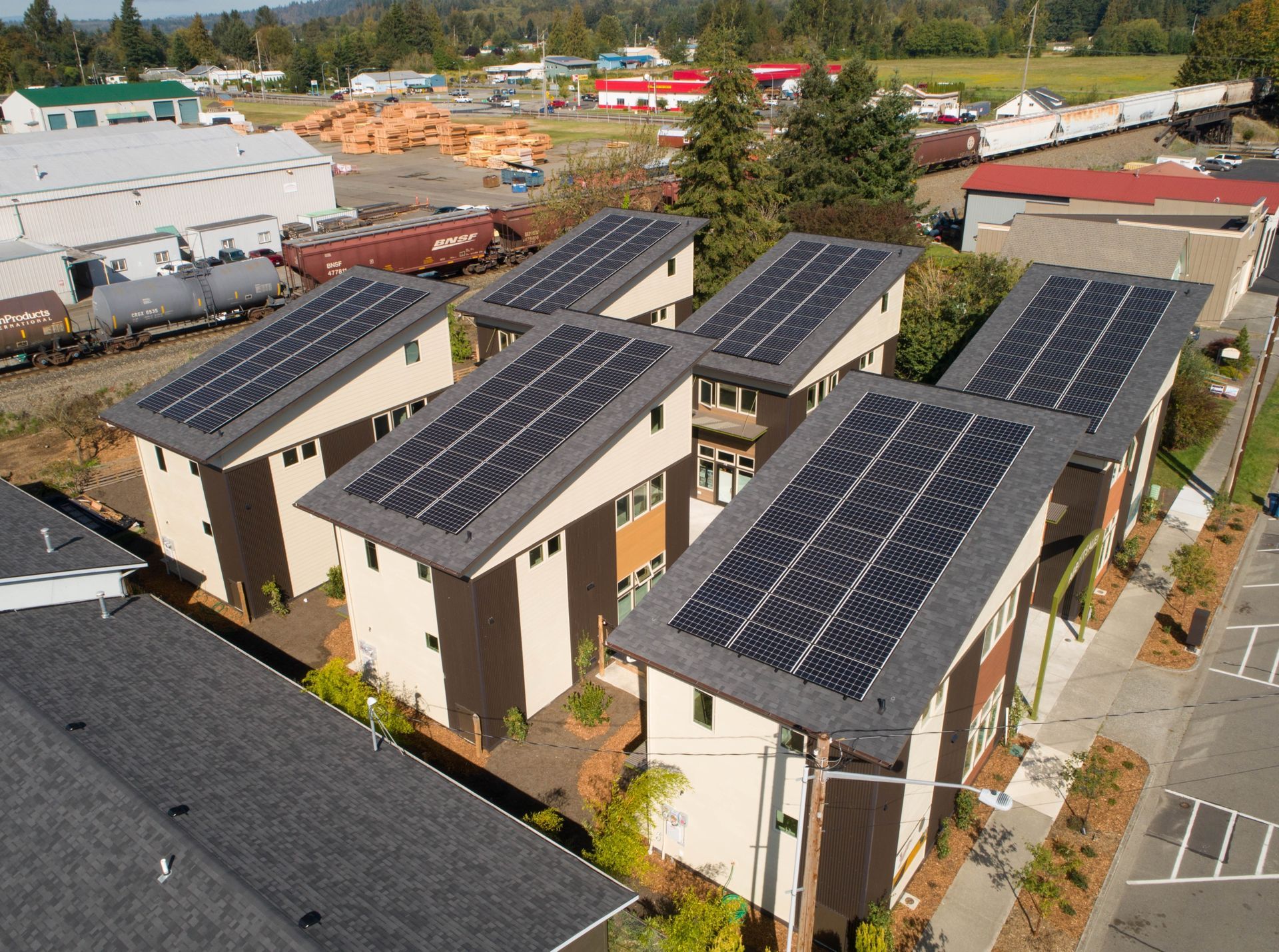 an aerial view of a building with solar panels on the roof