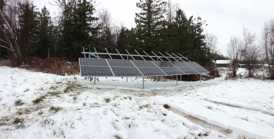 a solar panel is sitting in the middle of a snowy field
