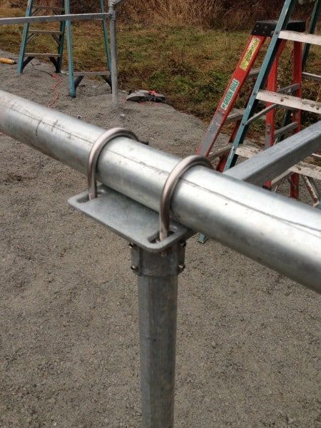 a close up of a metal pipe with a ladder in the background