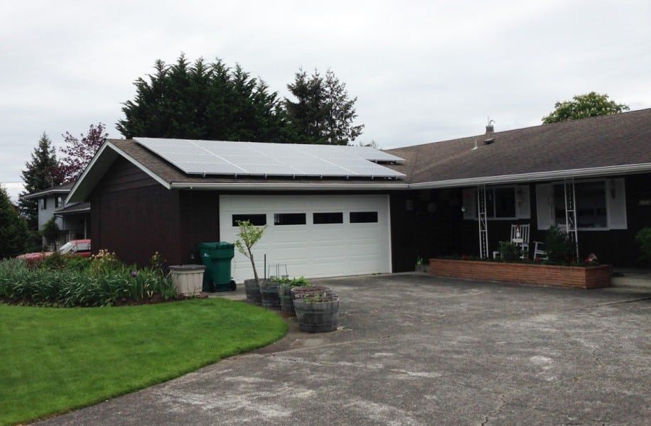 a house with a garage and solar panels on the roof