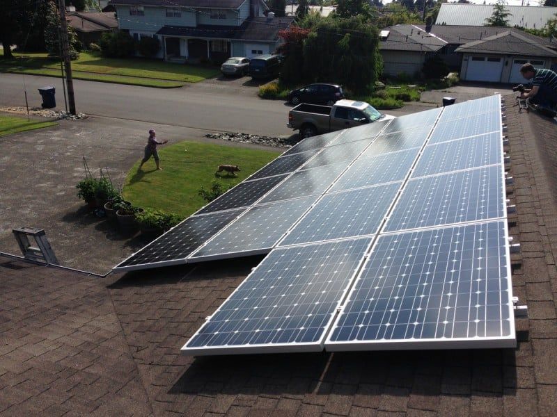 a row of solar panels on the roof of a house