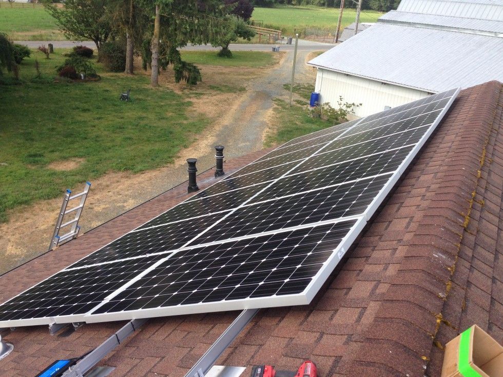 solar panels are being installed on the roof of a house