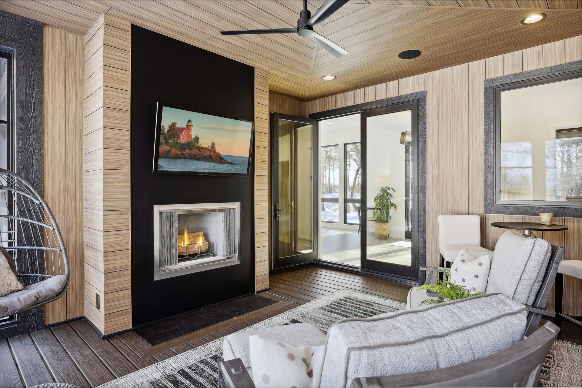 A living room with a fireplace and a flat screen tv.