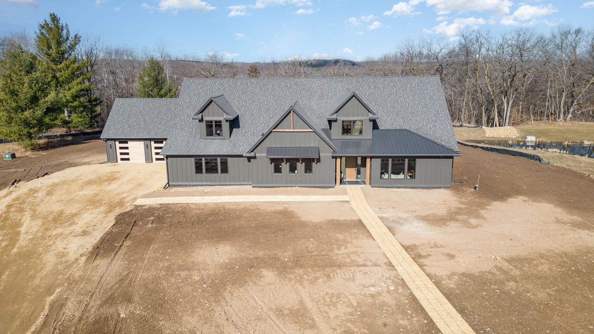 An aerial view of a house under construction in the middle of a dirt field.