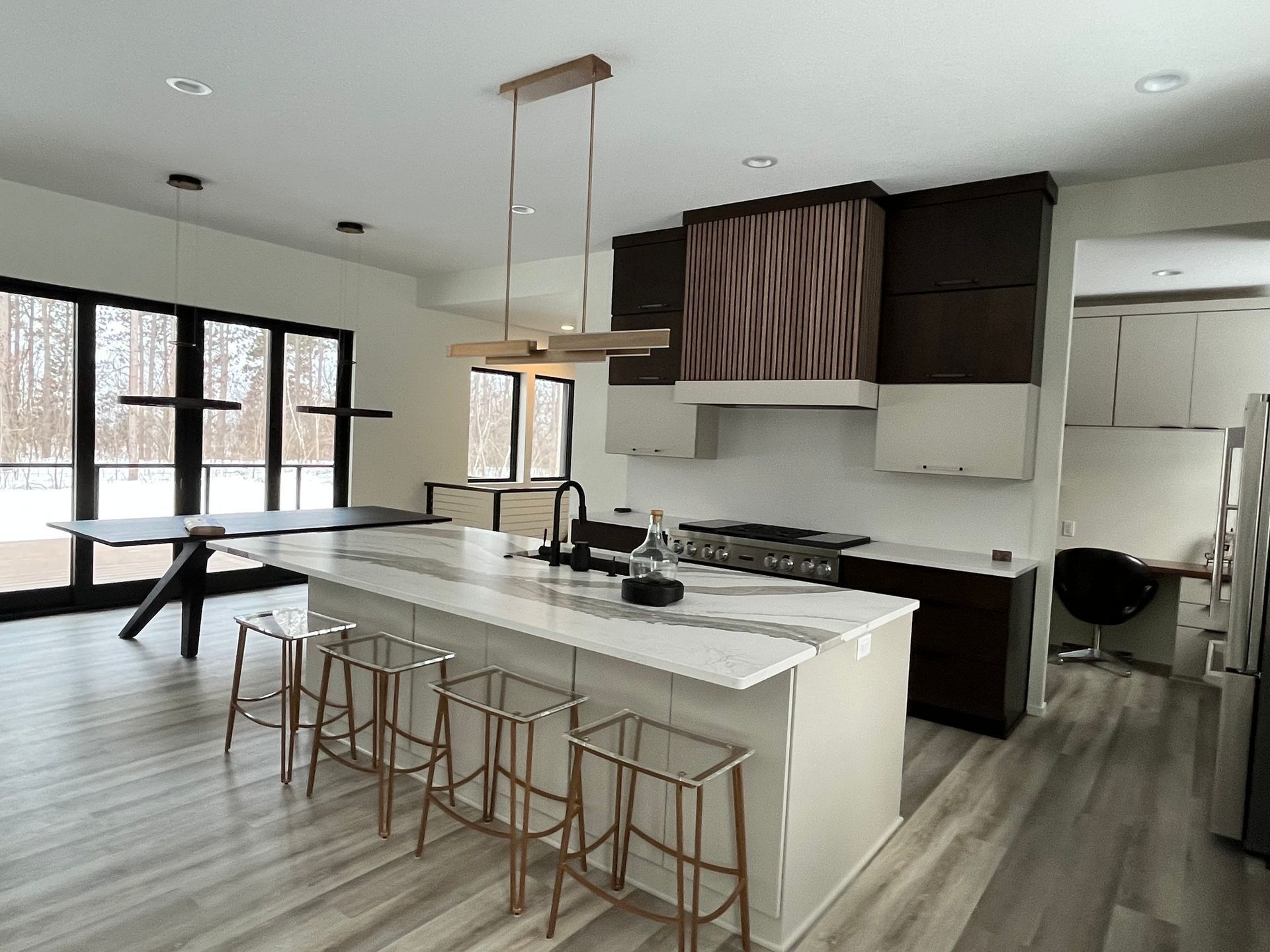 A kitchen with a large island and stools